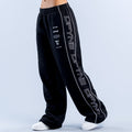 Black wide-leg joggers with elastic waistband and white side graphic print