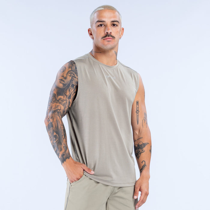 Beige sleeveless crew-neck tank top with straight hem, worn by a model