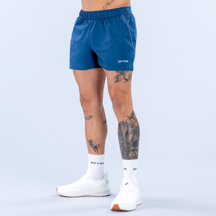 Men's blue training shorts with elastic waistband and small side logo