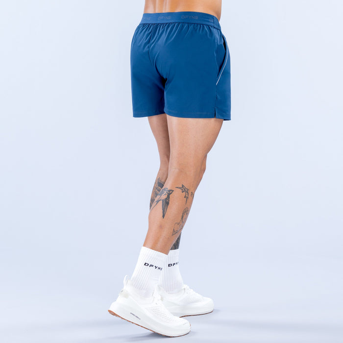 Men's blue training shorts with elastic waistband and small side logo