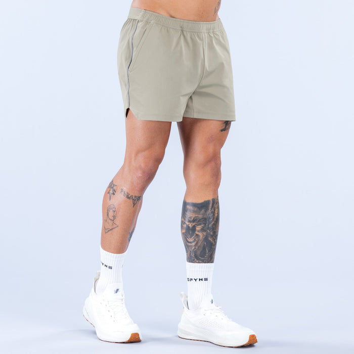 Olive 4-inch training shorts front view with elastic waistband and subtle logo