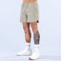 Olive 6-inch training shorts with elastic waistband and side seam accents