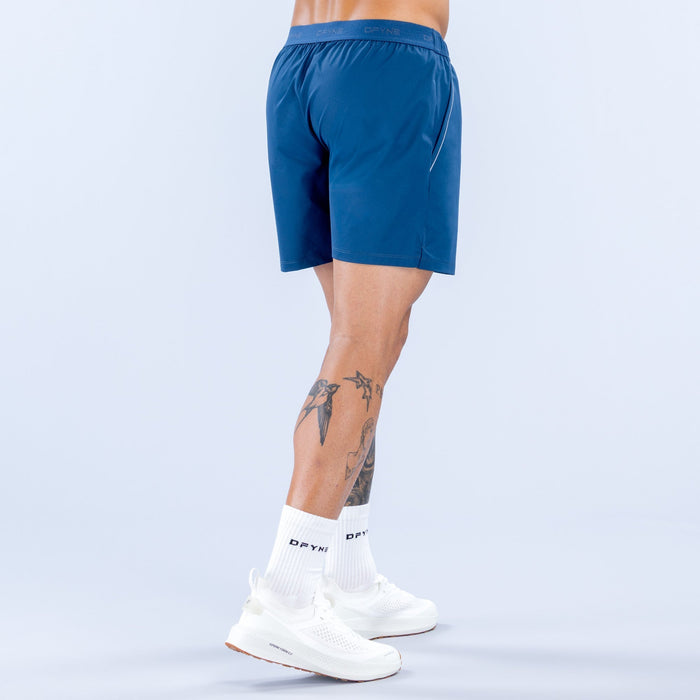 Men's blue training shorts, back view, elastic waistband, logo at hem, 6 in inseam