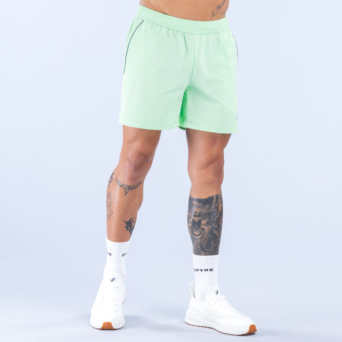 Light green training shorts with relaxed fit, elastic waistband and 6-inch inseam