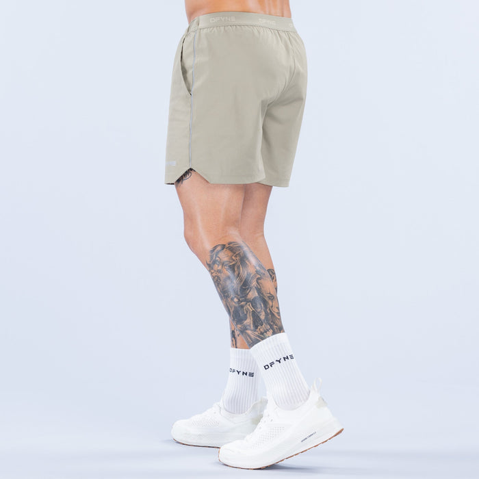 Olive 6-inch training shorts with elastic waistband and side seam detailing