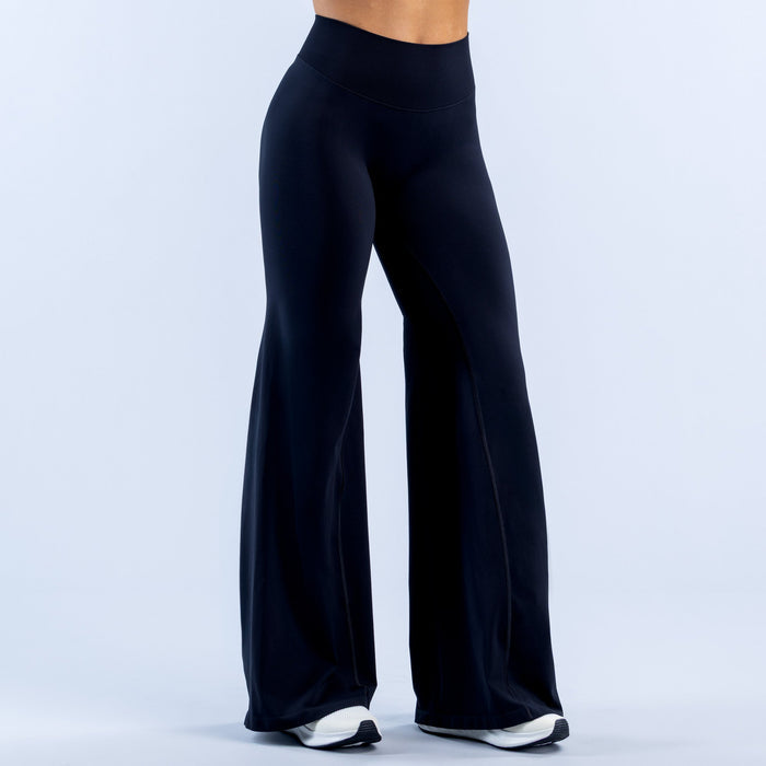 Dark navy high-rise flared leggings with smooth stretch fabric and wide bell silhouette