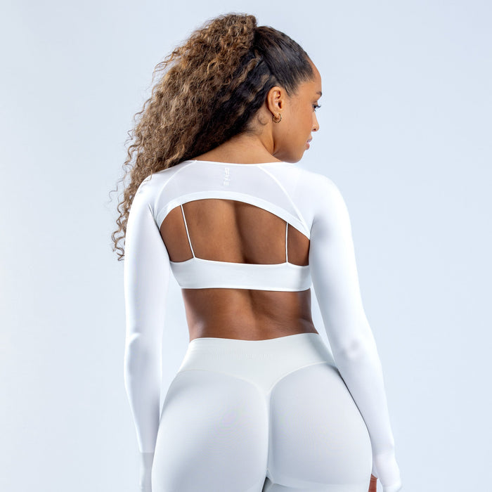 White long-sleeve shrug with open back strap detail and scoop neckline