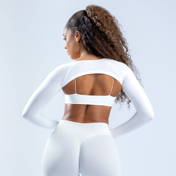 White long-sleeve shrug with open back band and bra-like cutout
