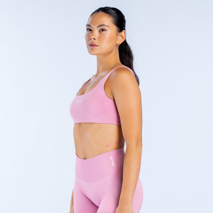 Pink scoop-back sports bra with wide scoop neckline and racerback straps