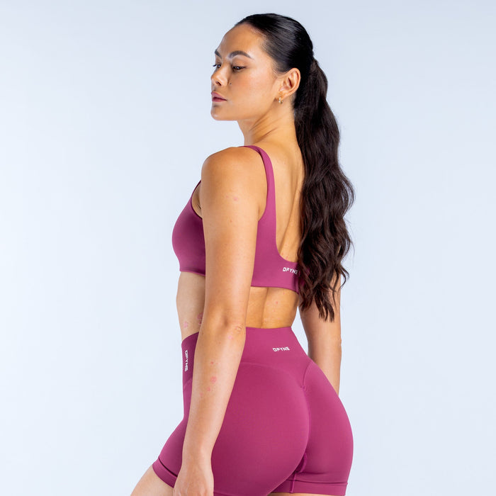 Magenta scoop back sports bra with open back and narrow shoulder straps
