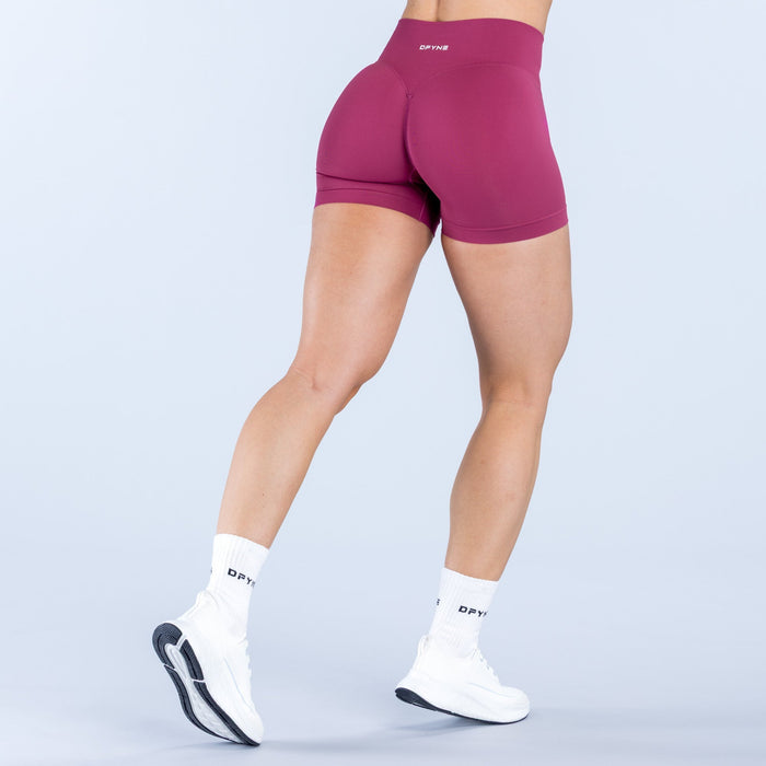 Magenta 4.5-inch athletic shorts with small back logo and full rear coverage