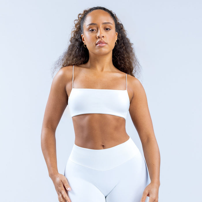 White strappy bra with thin spaghetti straps and straight neckline, front view.