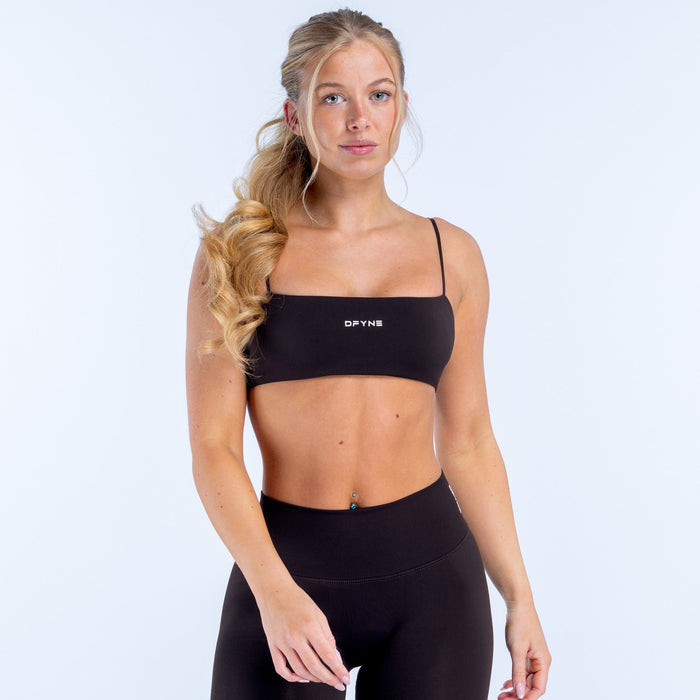 Black strappy sports bra with thin shoulder straps and wide underband
