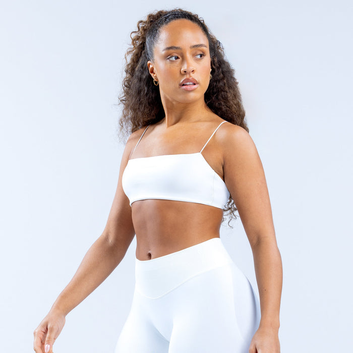White strappy bra with thin straps and straight neckline, front angled view.