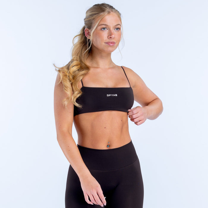 Black strappy sports bra with thin straps and small front logo band