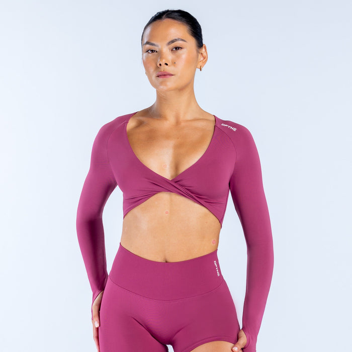 Twist-front long sleeve athletic top in deep plum with V-neck and wrap crossover