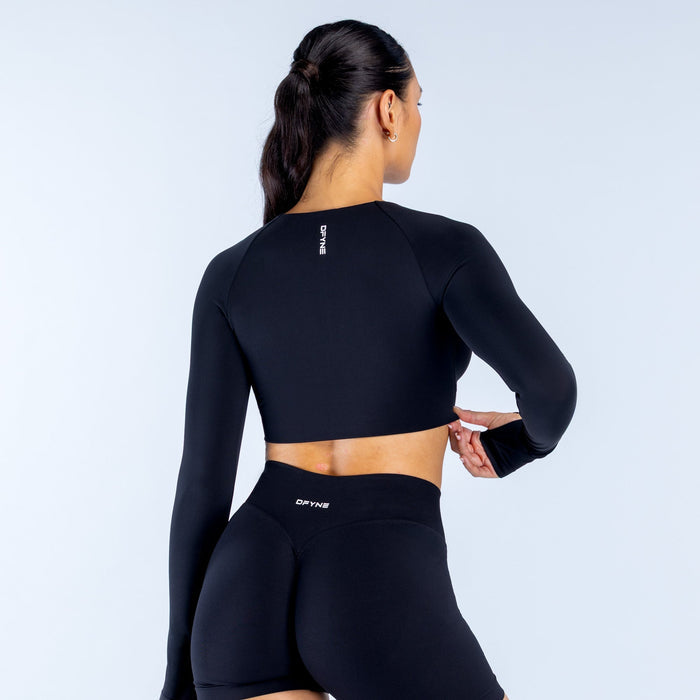 Black long-sleeve crop top with scoop back and small neck logo