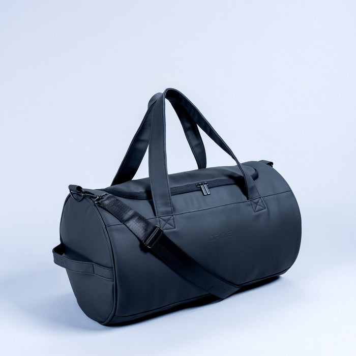 Dark duffle bag with top handles, front zipper pocket, and adjustable shoulder strap