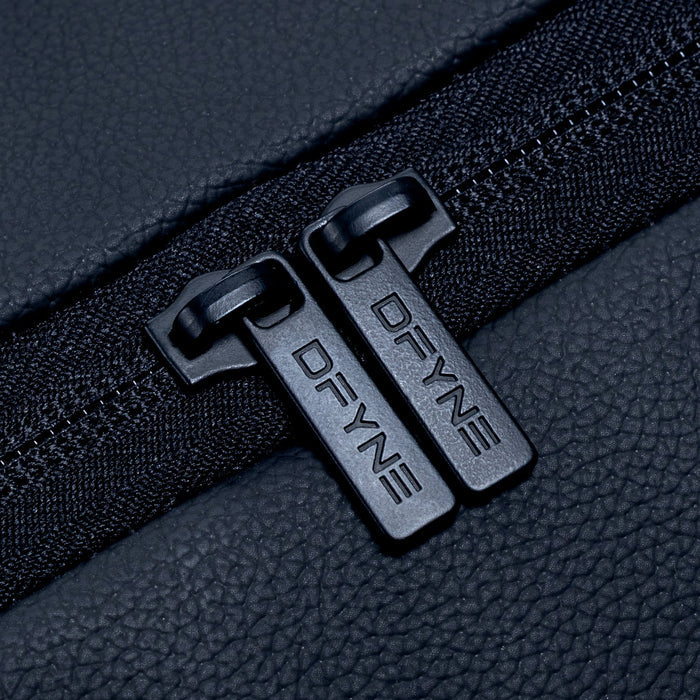 Duffle bag zipper with two black metal pull tabs on textured fabric