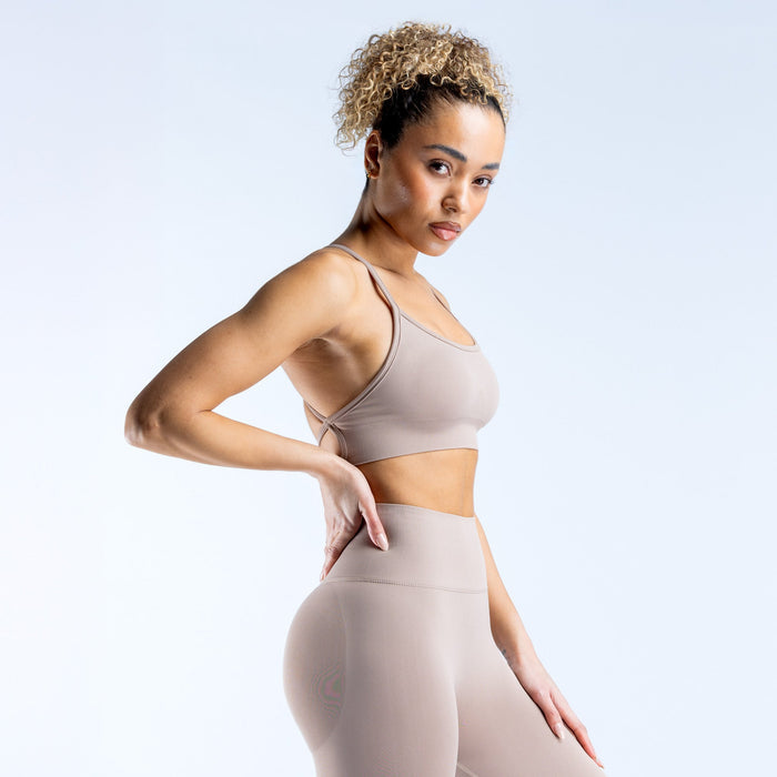 Taupe backless sports bra with thin straps and fitted elastic band