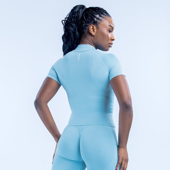 Light blue short-sleeve zip athletic top, back view with full-length zipper