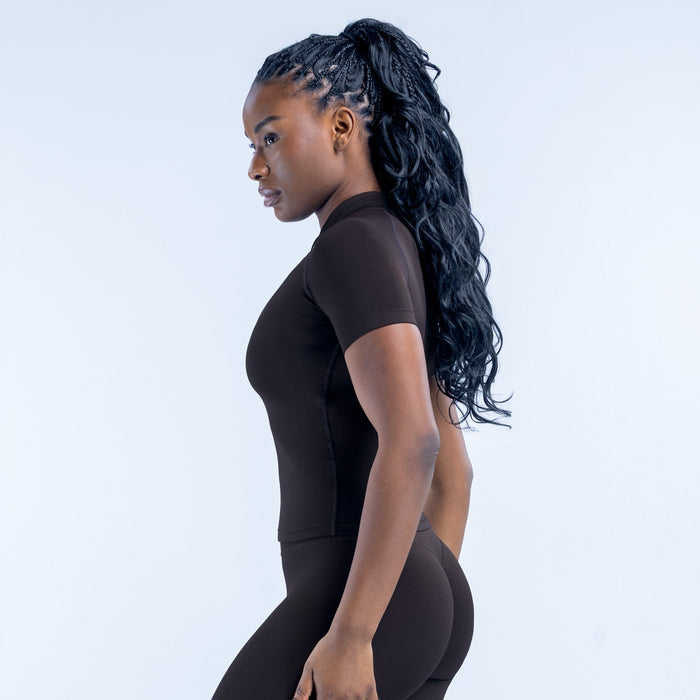 Black short-sleeve zip-up athletic top, side view, fitted with back logo