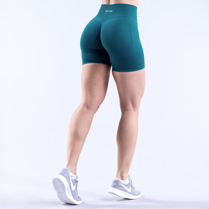 Women's teal 4.5-in athletic shorts, side view showing snug fit