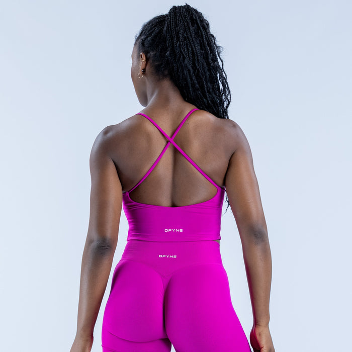 Fuchsia strappy workout top, open-back crisscross straps, fitted