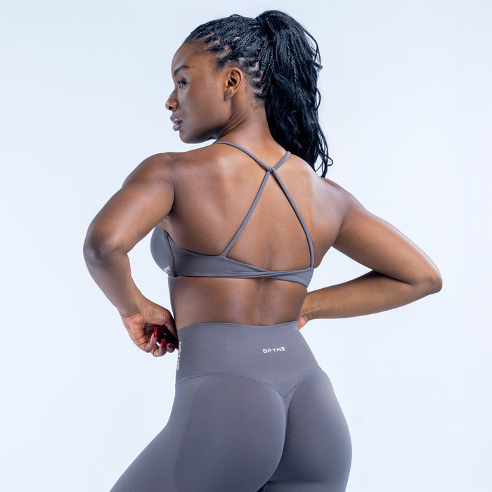 Dark gray twist-back sports bra with crisscross back straps and open back