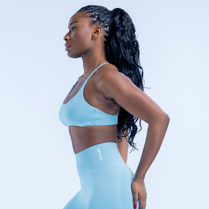 Light blue sports bra with crossed back straps and angled side view