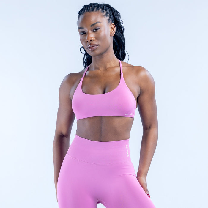 Pink sports bra with scoop neckline and slim adjustable straps
