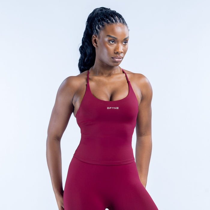 Burgundy sports tank top with thin straps and DYN logo