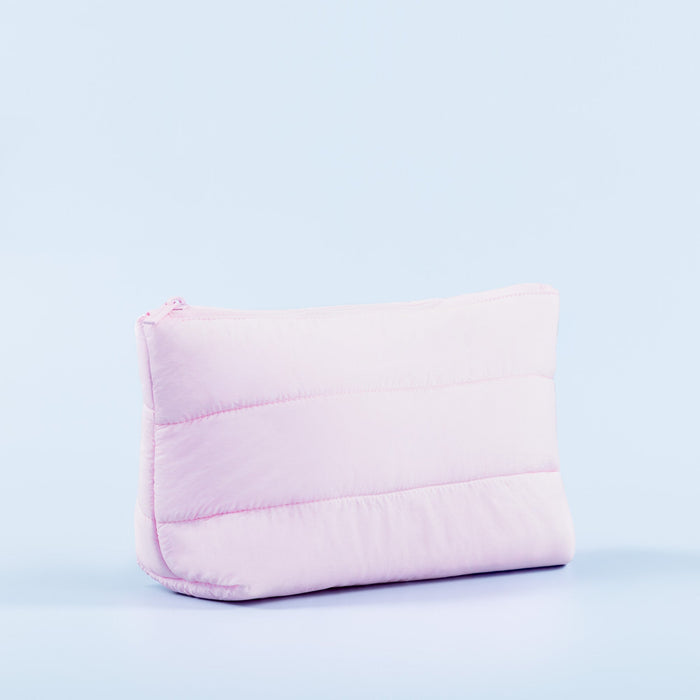 Light pink padded pouch, side view, zip-top closure and curved base