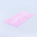 Pink gym towel with geometric pattern, folded