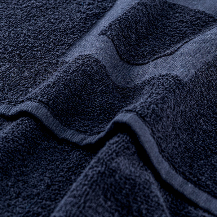 Navy gym towel close-up: textured loops and stitched edge