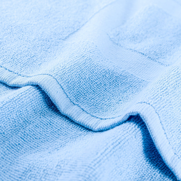 Light blue gym towel with stitched edge and textured terry loops