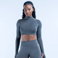 Dark gray cropped long-sleeve athletic top with quarter-zip and high collar
