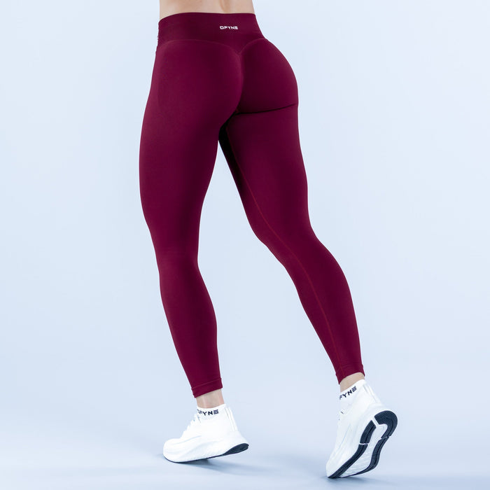 Maroon compression leggings with contoured panels and ankle cuffs