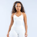 White longline strappy top with V-neck and spaghetti straps, fitted silhouette