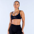 Black scoop-neck sports bra with racerback straps and DPYNE logo at center