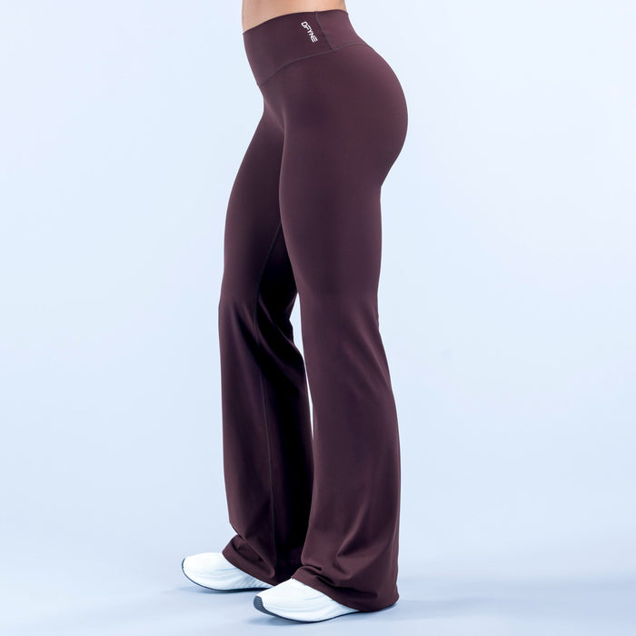 Burgundy high-waist flare pants with logo label on waistband and draped wide legs