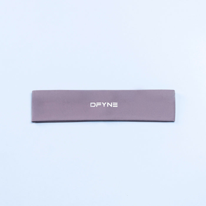 Mauve Origin headband with DFYNE logo, flat lay.