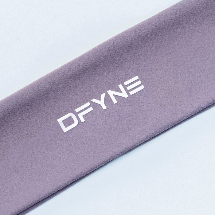 Close-up of mauve Origin headband fabric with DFYNE lettering.