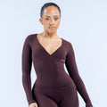 Dark maroon long-sleeve V-neck fitted top with small chest logo.