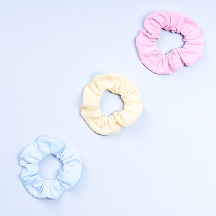 3-pack scrunchies in light pink, cream, and light blue with gathered elastic