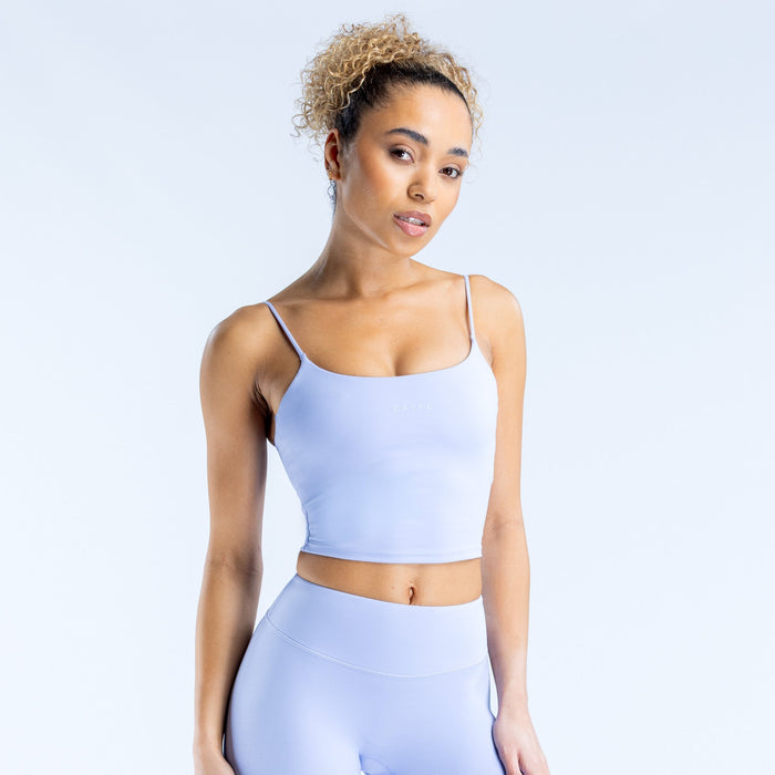 Light blue strappy crop top with thin straps and smooth fitted silhouette
