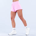 Pink training shorts with elastic waistband and relaxed fit