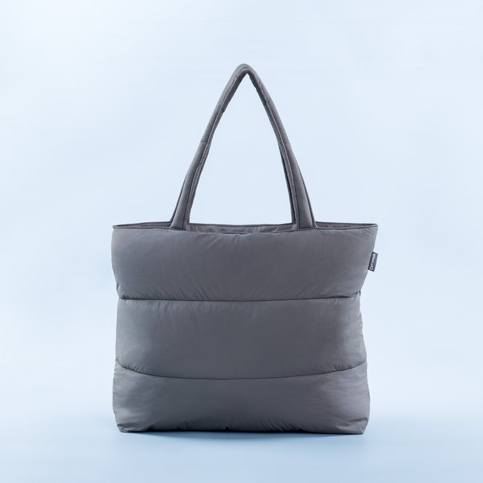 Gray padded tote bag with rounded handles and quilted front panel