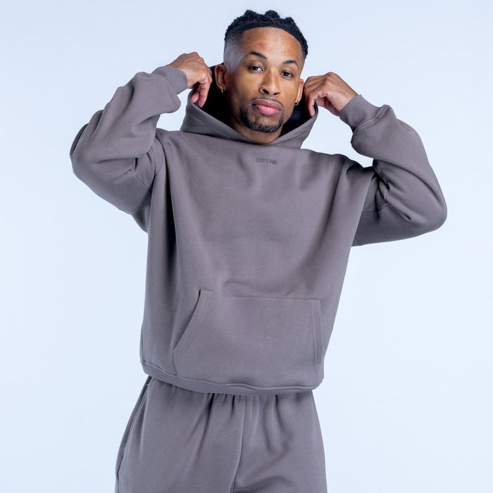 Dark gray pullover hoodie with hood, front pocket, and small chest logo