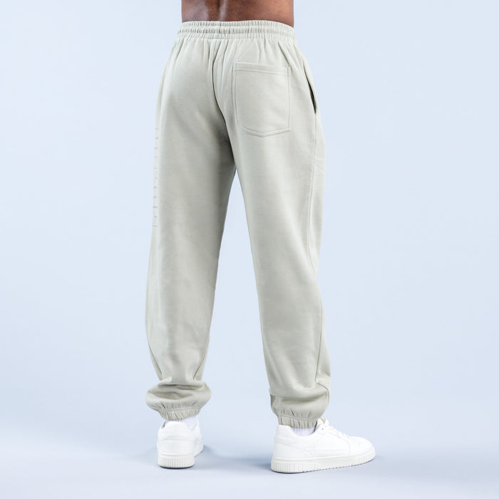 Cream joggers with elastic waistband, back pocket, and ribbed ankle cuffs